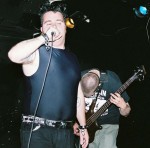 Ed's shiny nipples pierce the audience as Nick ducks out of the way.